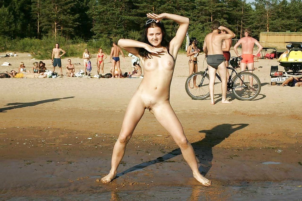 Nudist gilrs spreading legs on beach