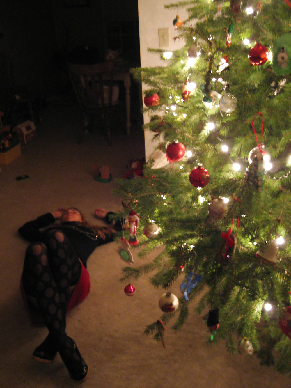 wife posing next to christmas tree pict gal