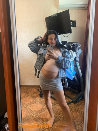 pregnant brunette in sheer pantyhose         