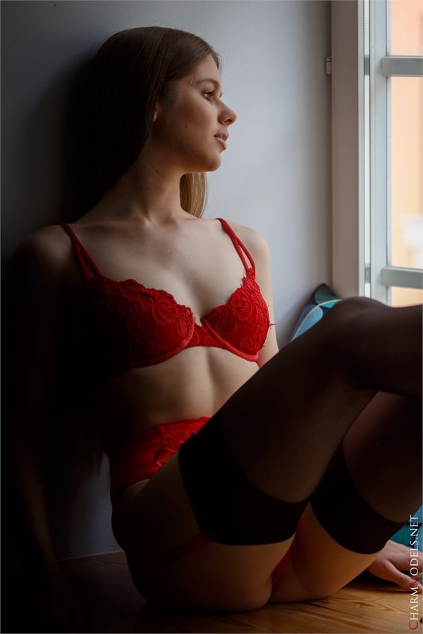 Evelina on the window in red lingerie - 16 Photos 